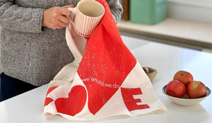 Love tea towel printed heart with the words printed with the words "we are what we do" made in the USA