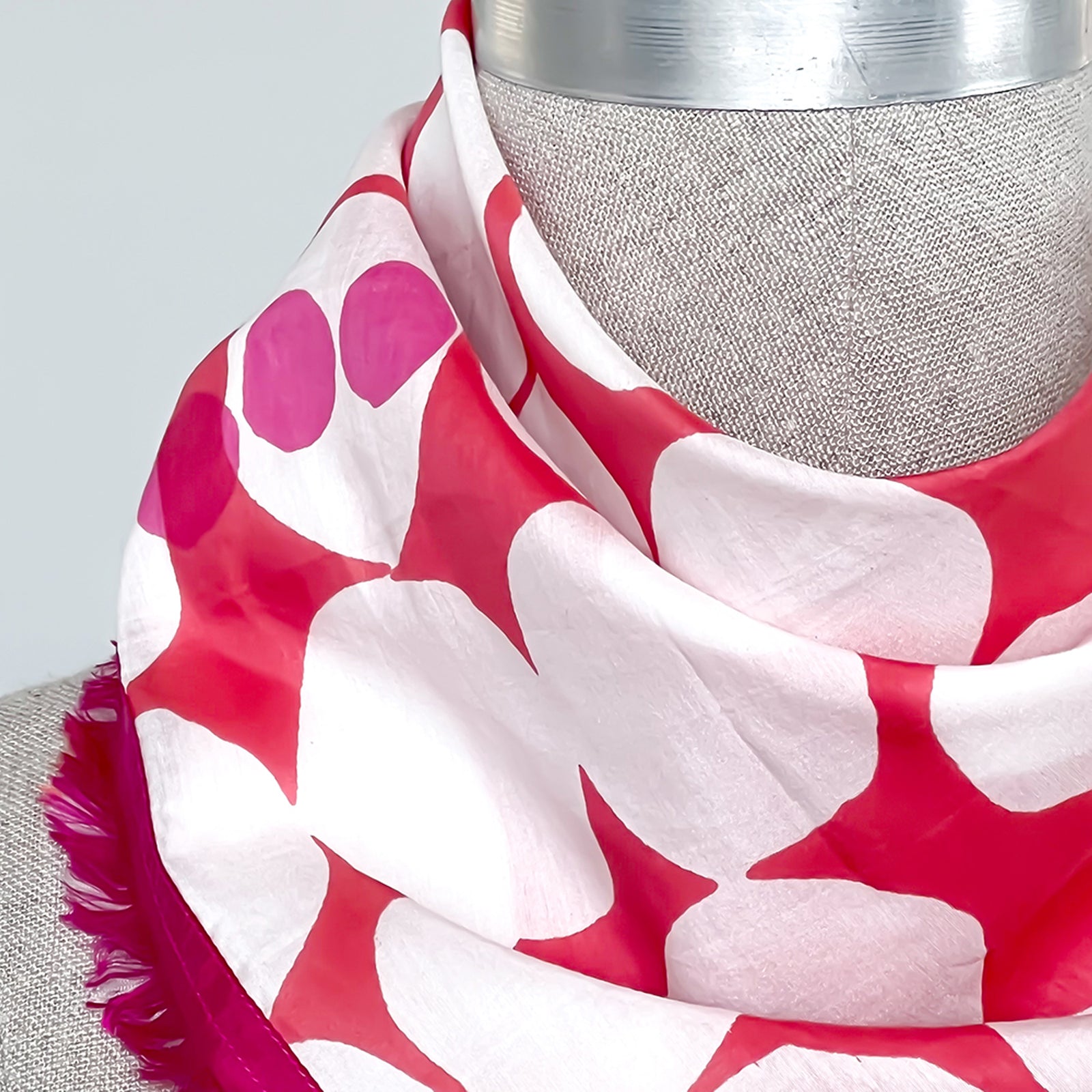 Cotton Silk Mini scarf, Archie Fuchsia design by PilgrimWaters, with up cycled eyelash sari edges on all sizes, modeled on a mannequin. Handprinted in India.