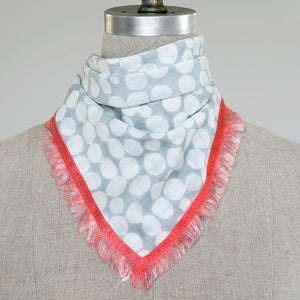 Cotton Silk Domino Sky Mini bandana with Ember eyelash edges tied for display on a mannequin. 