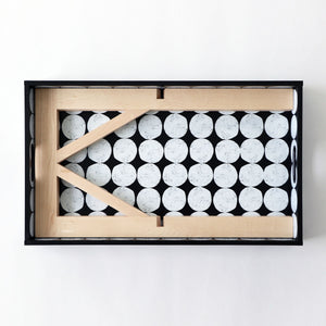 A large maple tray stand disassembled and sungly fitting in a tray.