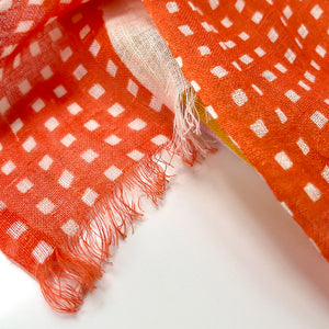 Close-up of Banjo Coral Cotton Linen fabric showing the abstract check pattern.