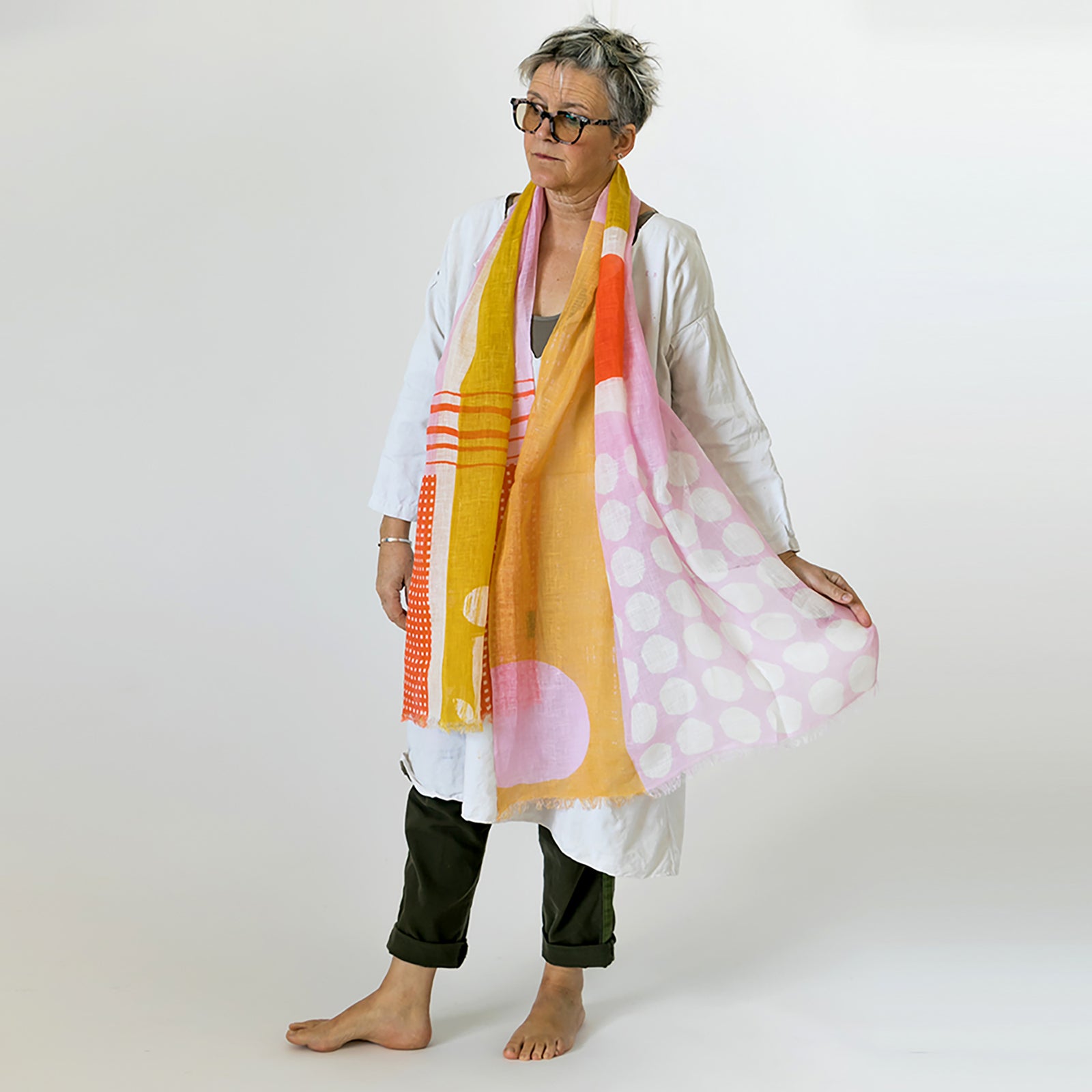 Banjo Coral large cotton linen scarf being styled, showing the large abstract design.
