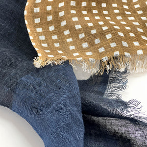 Close-up of Banjo Harbor Cotton Linen scarf showing frayed fringe detail.