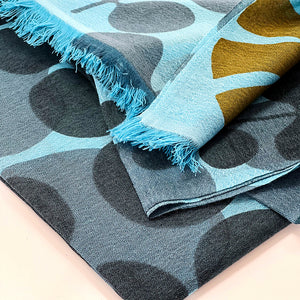 Echo Escape merino wool scarf closeup showing the intricate leafy plant design with the short edge fringe and weave detail, hand silk-screened in Nepal, design by PilgrimWaters.