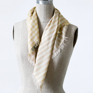 Littles Esme gingham merino wool silk neckerchief draped on a mannequin, showing four-sided fringe — © 2026 PilgrimWaters.