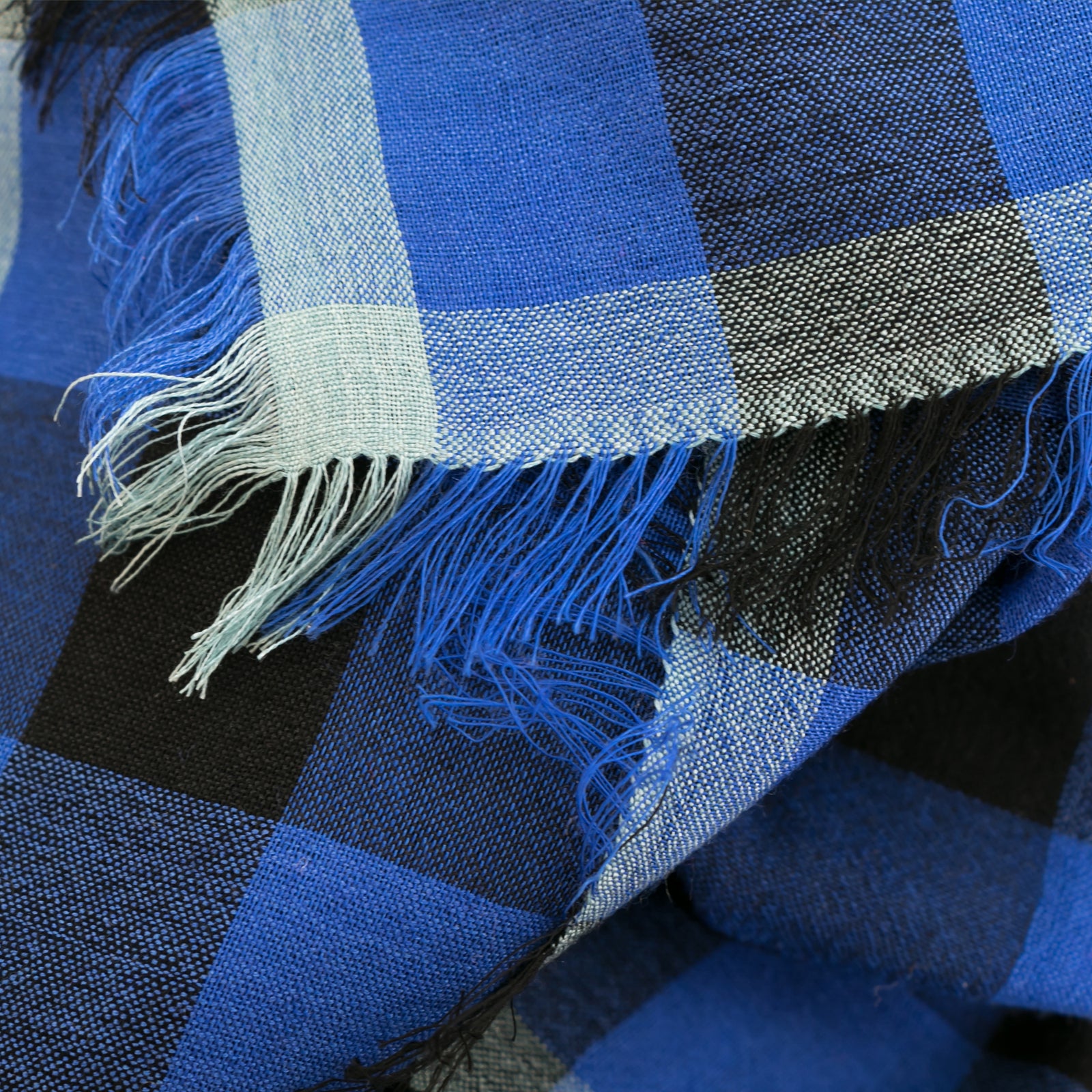 Littles Felix gingham merino wool silk neckerchief draped on a mannequin, showing four-sided fringe — © 2026 PilgrimWaters.