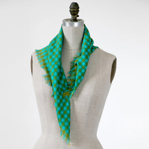 Littles Fern gingham merino wool silk neckerchief draped on a mannequin showing the soft fringes — © 2026 PilgrimWaters.