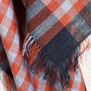 Littles Rue gingham gingham neckerchief close-up showing rust, grey, and white check with eyelash fringe — © 2026 PilgrimWaters.