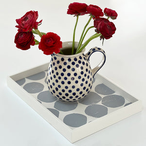 Gray dot pattern mini valet handcrafted wooden tray designed by Keith Waters and design pattern by Susy Pilgrim Waters with a polka dot jug and flowers.