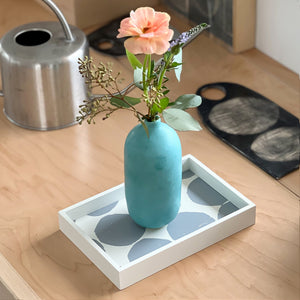 PilgrimWaters Gray Mini-Mini tray featuring a gray handprinted dot pattern, styled on a surface with a turquoise ceramic bud vase holding a pink flower.