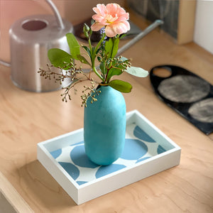 PilgrimWaters Sky Mini-Mini tray featuring a bold graphic dot pattern, styled on a surface with a turquoise ceramic bud vase holding a pink flower.
