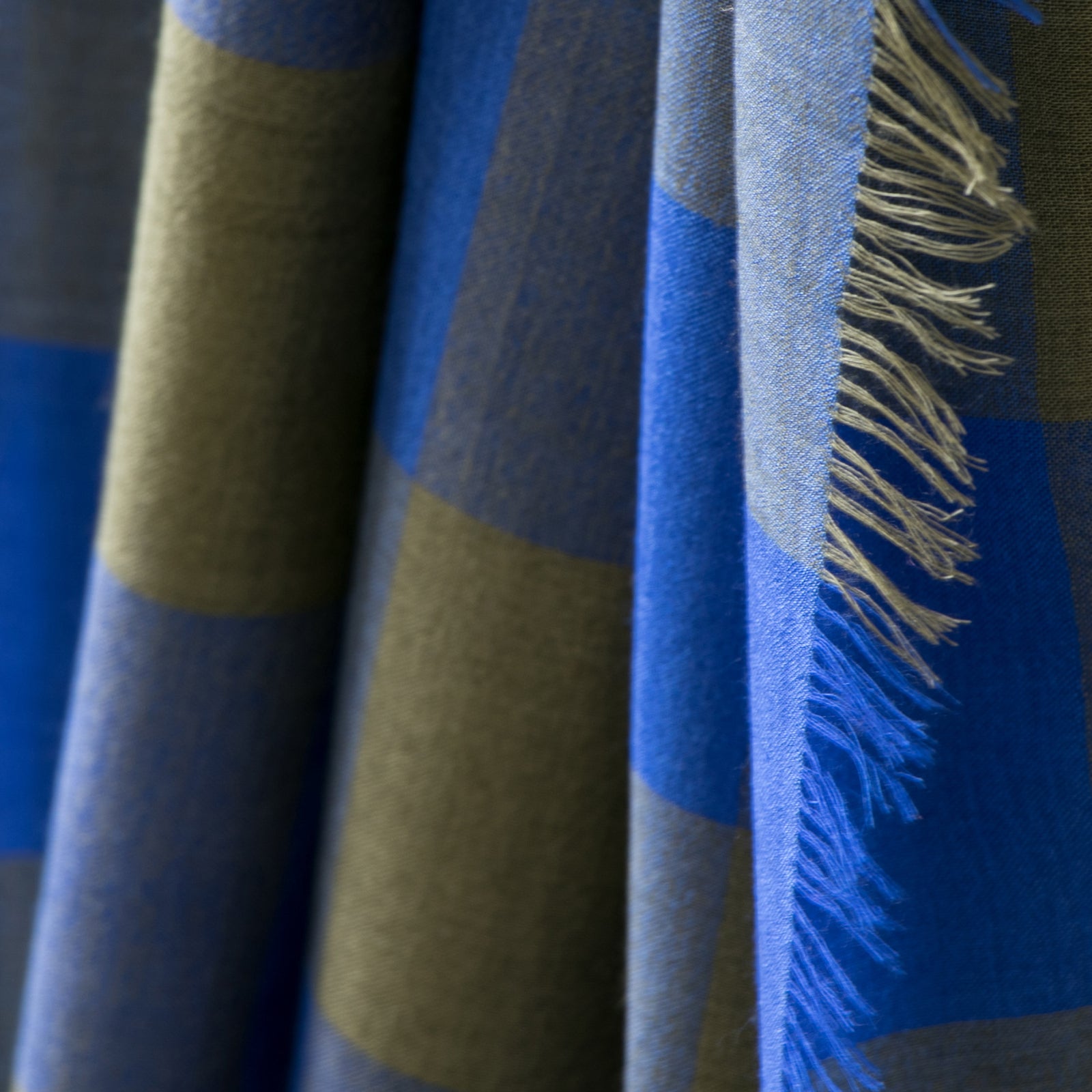 Mannequin draped in Billy, a large gingham scarf. Made in Nepal for PilgrimWaters.