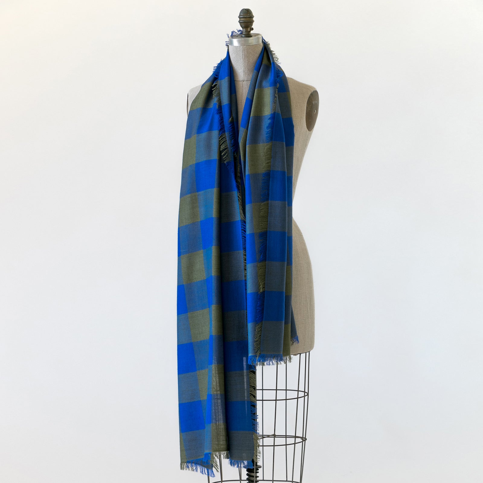 Mannequin draped in Billy, a large gingham scarf. Made in Nepal for PilgrimWaters.