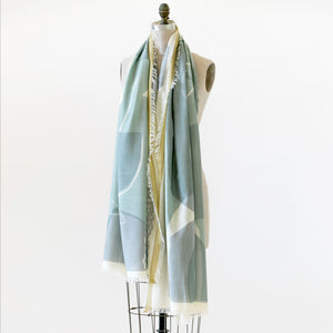 A cotton silk scarf called 'Sparrow' on a mannequin. The design displays  large abstract shapes and colors.